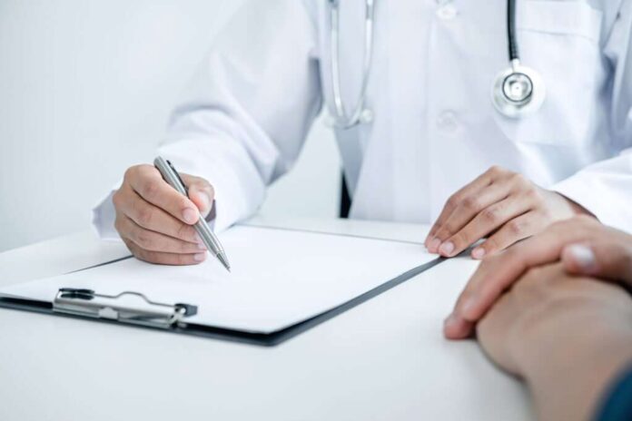 Doctor is explaining the symptoms to the patient at medical clin