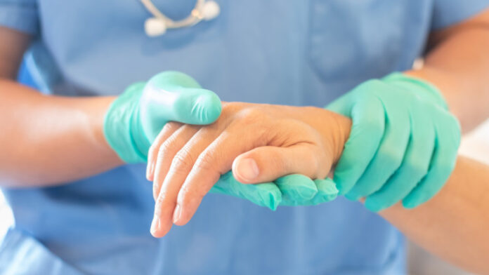Surgeon, surgical doctor, anesthetist or anesthesiologist holding patient's hand for health care trust and support in professional ER surgical operation, medical anesthetic safety, healthcare concept