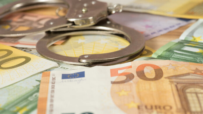 Handcuffs and Euro banknotes
